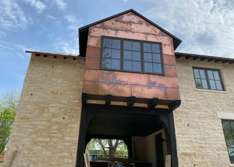 Copper metal panel facade on a stone building for Skylight Installation in Palmer