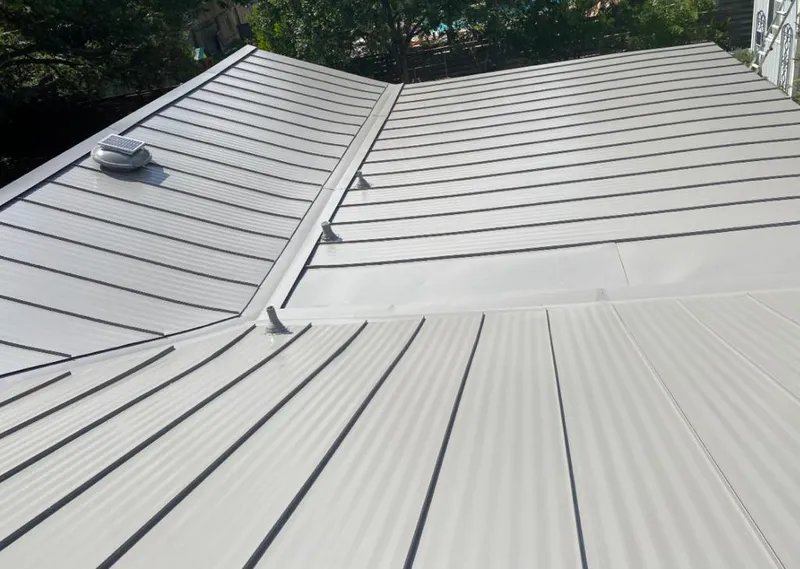 Solar attic fan installed on a metal roof for Roof Ventilation in Palmer